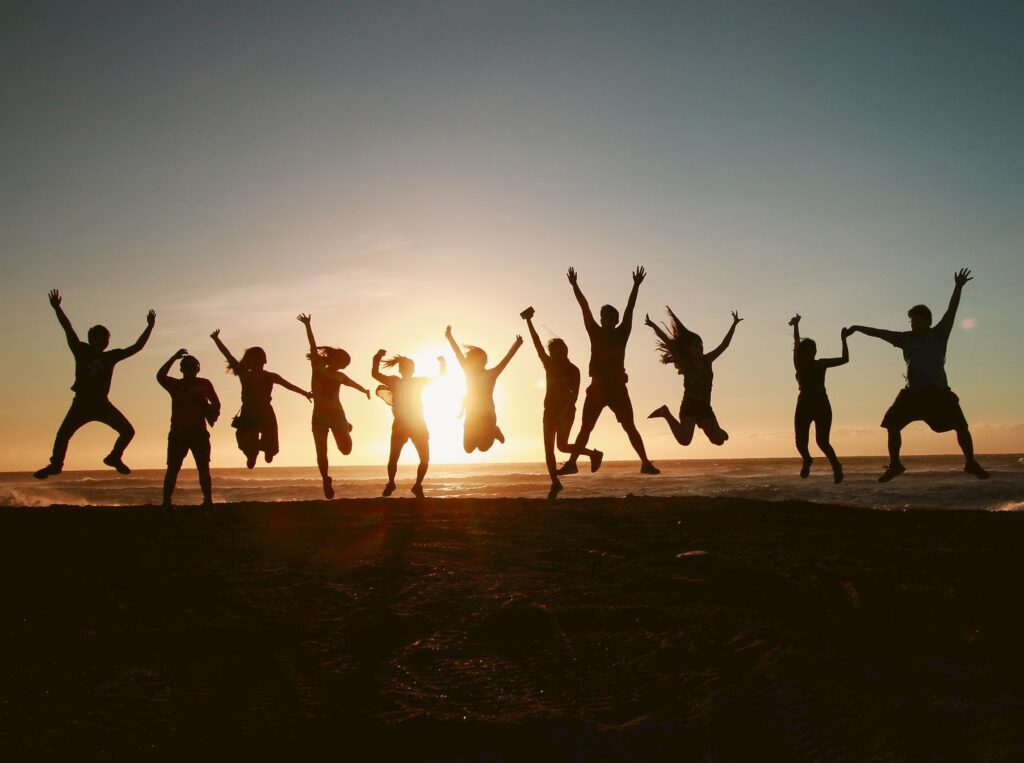 Adults jumping in the sunset